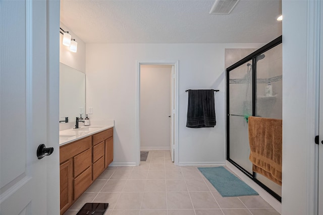 12327 Buck Sable Ln, Houston, TX 77044 - full bath with double vanity, a shower stall, tile patterned floors, and a textured ceiling