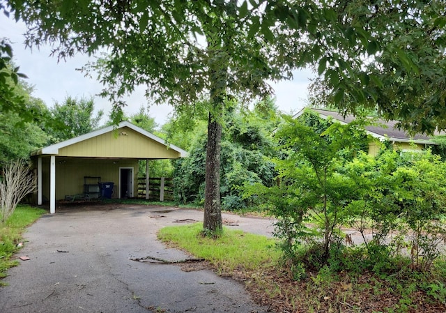 25321 Bluff View Ct, Magnolia, TX 77355 - garage with asphalt driveway and a detached carport