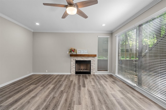 161 Litchfield Ln, Houston, TX 77024 - unfurnished living room featuring wood finished floors, a stone fireplace, ornamental molding, recessed lighting, and ceiling fan