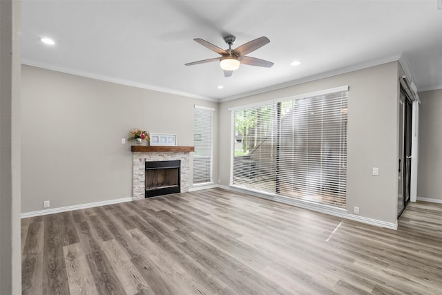161 Litchfield Ln, Houston, TX 77024 - unfurnished living room featuring crown molding, a ceiling fan, wood finished floors, a stone fireplace, and recessed lighting
