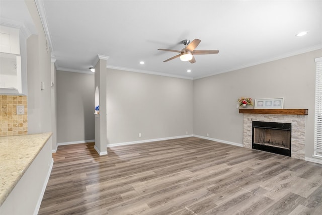 161 Litchfield Ln, Houston, TX 77024 - unfurnished living room featuring a ceiling fan, light wood finished floors, a fireplace, recessed lighting, and ornamental molding