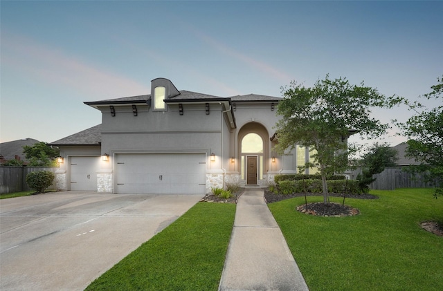 21015 Arden Park Dr, Richmond, TX 77407 - view of front facade with stone siding, driveway, a garage, and stucco siding