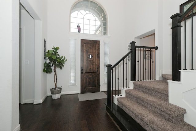 21015 Arden Park Dr, Richmond, TX 77407 - foyer with dark wood finished floors, a high ceiling, stairway, and baseboards