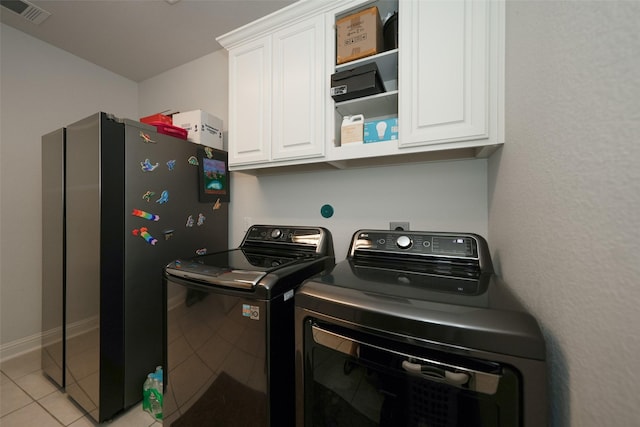 21015 Arden Park Dr, Richmond, TX 77407 - laundry room featuring cabinet space, washer and dryer, light tile patterned flooring, and baseboards