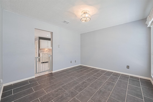 3718 Sweetgum Hill Ln, Houston, TX 77345 - unfurnished room featuring baseboards and dark tile patterned flooring