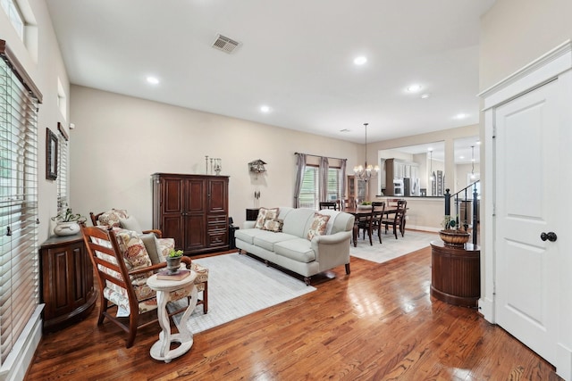 121 E 22nd St, Houston, TX 77008 - living room with wood finished floors, a chandelier, and recessed lighting