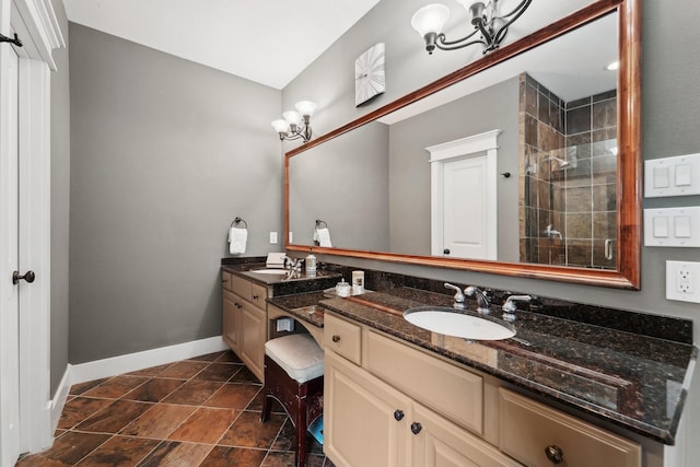 121 E 22nd St, Houston, TX 77008 - full bathroom featuring double vanity, a chandelier, a shower stall, and baseboards