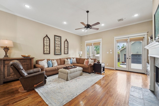 121 E 22nd St, Houston, TX 77008 - living area with a fireplace with flush hearth, wood finished floors, recessed lighting, a ceiling fan, and crown molding