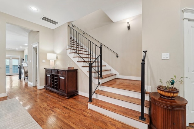 121 E 22nd St, Houston, TX 77008 - stairs featuring wood finished floors, baseboards, recessed lighting, and french doors