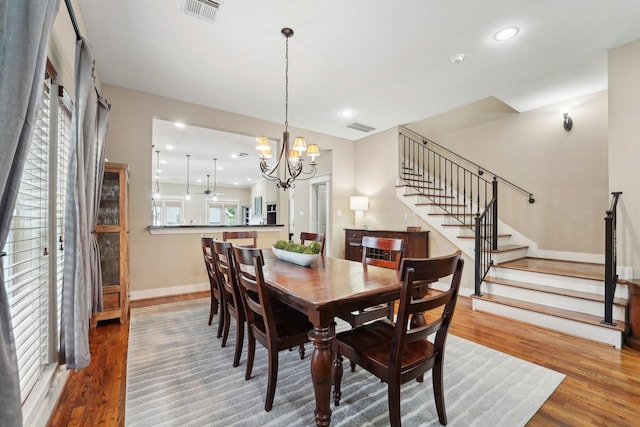 121 E 22nd St, Houston, TX 77008 - dining area featuring stairs, a chandelier, wood finished floors, baseboards, and recessed lighting