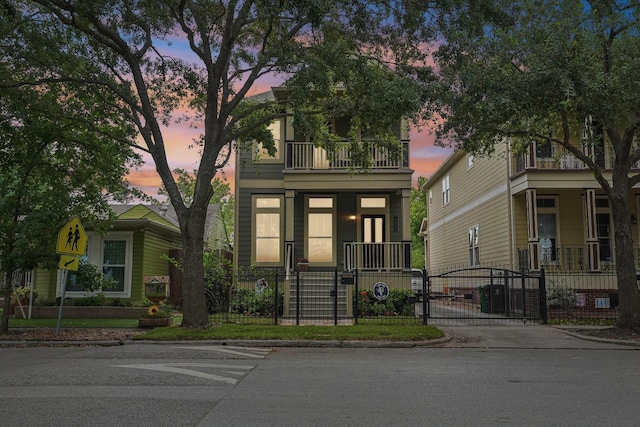 121 E 22nd St, Houston, TX 77008 - view of front facade featuring covered porch, a gate, a balcony, and a fenced front yard