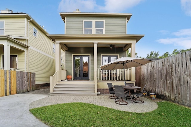 121 E 22nd St, Houston, TX 77008 - back of property featuring french doors, a fenced backyard, covered porch, and a patio
