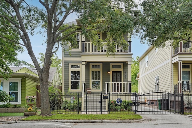 121 E 22nd St, Houston, TX 77008 - view of front facade with a balcony, a gate, a fenced front yard, and covered porch