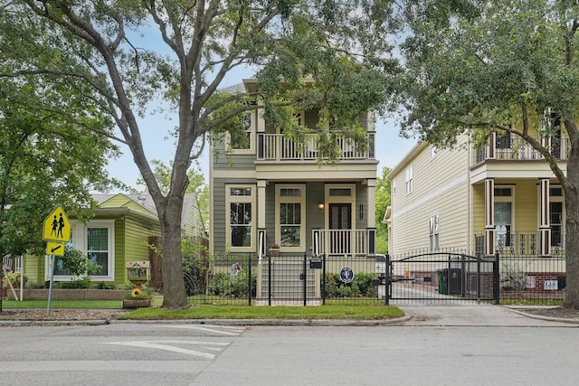 121 E 22nd St, Houston, TX 77008 - view of front facade featuring a balcony, a gate, covered porch, and a fenced front yard