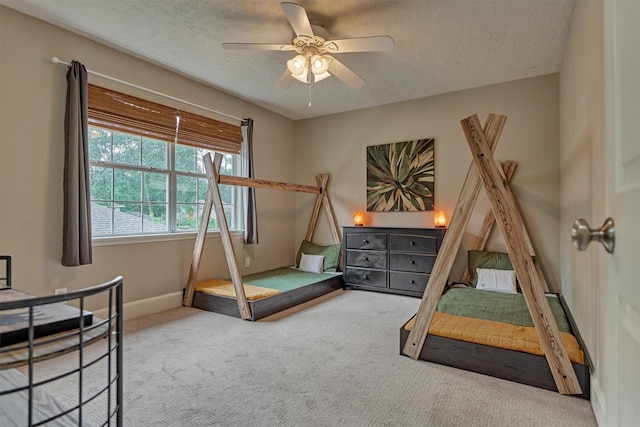 6411 Elmgrove Rd, Spring, TX 77389 - bedroom with carpet floors, a textured ceiling, baseboards, and a ceiling fan
