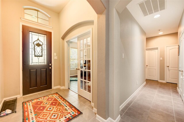 6119 Cresting Knolls Cir, Richmond, TX 77407 - entrance foyer with tile patterned flooring, arched walkways, and recessed lighting