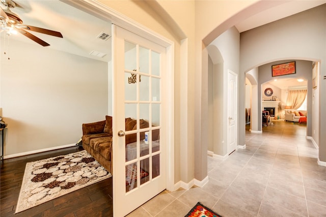 6119 Cresting Knolls Cir, Richmond, TX 77407 - hall featuring arched walkways, vaulted ceiling, and tile patterned flooring