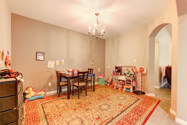6119 Cresting Knolls Cir, Richmond, TX 77407 - dining room featuring arched walkways, a chandelier, and tile patterned floors