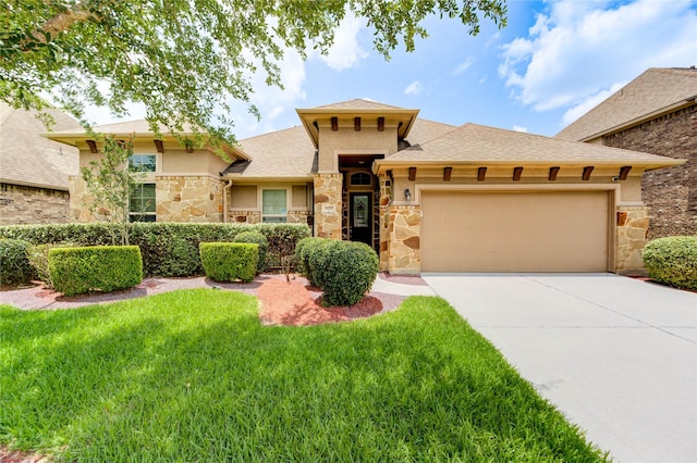 6119 Cresting Knolls Cir, Richmond, TX 77407 - view of front facade featuring stone siding, an attached garage, concrete driveway, stucco siding, and a front yard