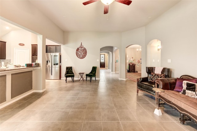 6119 Cresting Knolls Cir, Richmond, TX 77407 - living area with arched walkways, light tile patterned flooring, a ceiling fan, and lofted ceiling