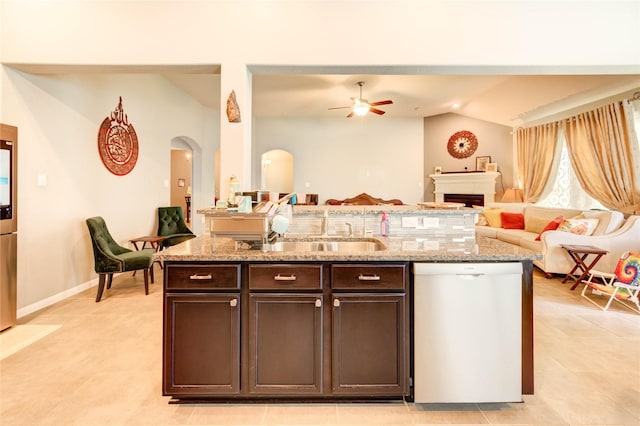 6119 Cresting Knolls Cir, Richmond, TX 77407 - kitchen featuring dishwasher, a ceiling fan, open floor plan, lofted ceiling, and dark brown cabinetry