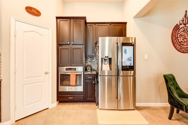 6119 Cresting Knolls Cir, Richmond, TX 77407 - kitchen featuring stainless steel appliances, light tile patterned flooring, and dark brown cabinetry