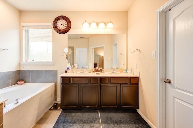 6119 Cresting Knolls Cir, Richmond, TX 77407 - bathroom with double vanity, a bath, and tile patterned floors
