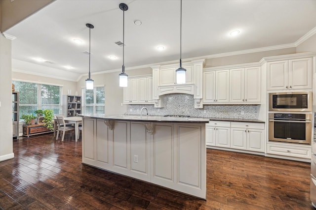 6815 Cottonwood Crest Ln, Katy, TX 77493 - kitchen featuring appliances with stainless steel finishes, ornamental molding, dark wood finished floors, decorative backsplash, and a kitchen breakfast bar