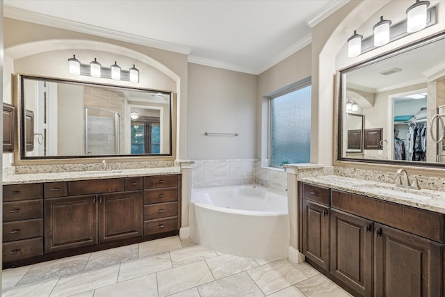 6815 Cottonwood Crest Ln, Katy, TX 77493 - full bathroom featuring a shower stall, two vanities, a bath, crown molding, and a walk in closet