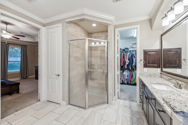 6815 Cottonwood Crest Ln, Katy, TX 77493 - bathroom featuring vanity, a shower stall, ceiling fan, baseboards, and a walk in closet