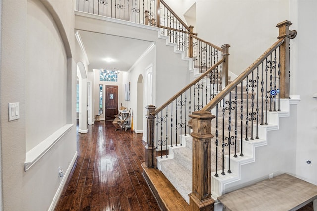 6815 Cottonwood Crest Ln, Katy, TX 77493 - foyer featuring arched walkways, hardwood / wood-style floors, crown molding, stairway, and baseboards