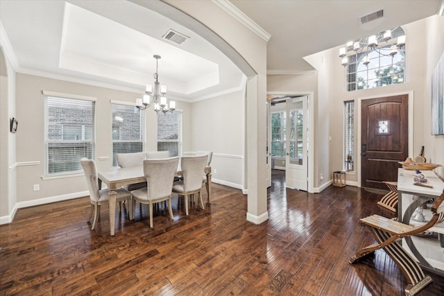 6815 Cottonwood Crest Ln, Katy, TX 77493 - dining space featuring a chandelier, hardwood / wood-style floors, baseboards, a raised ceiling, and ornamental molding