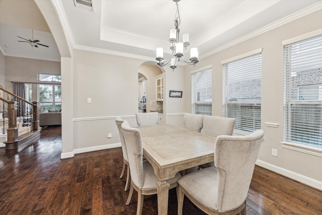 6815 Cottonwood Crest Ln, Katy, TX 77493 - dining room featuring a chandelier, arched walkways, hardwood / wood-style floors, ceiling fan, and crown molding