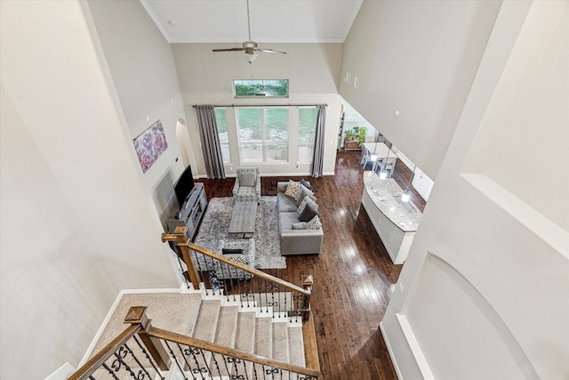6815 Cottonwood Crest Ln, Katy, TX 77493 - stairway featuring a towering ceiling, hardwood / wood-style flooring, a fireplace, crown molding, and ceiling fan