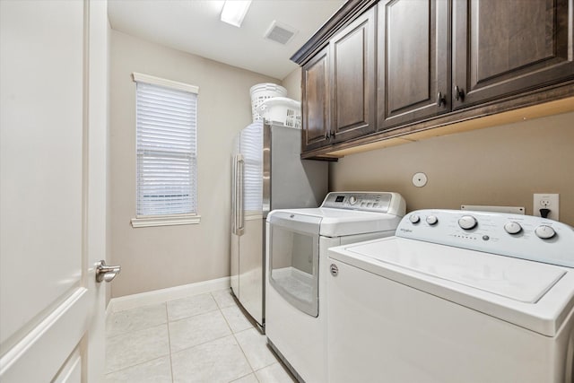 6815 Cottonwood Crest Ln, Katy, TX 77493 - laundry area with cabinet space, washing machine and dryer, baseboards, and light tile patterned floors