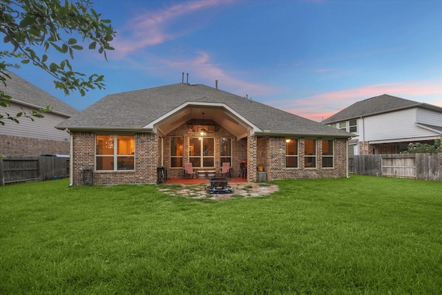 6815 Cottonwood Crest Ln, Katy, TX 77493 - rear view of property featuring brick siding, an outdoor fire pit, a patio, and roof with shingles