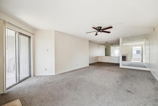 9700 Leawood Blvd Unit 216, Houston, TX 77099 - unfurnished living room featuring carpet floors, a fireplace, and a ceiling fan