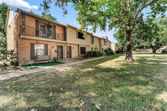 7322 Crownwest St Unit 7322, Houston, TX 77072 - townhome / multi-family property with brick siding, a balcony, and a front yard