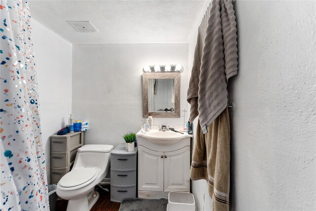 7322 Crownwest St Unit 7322, Houston, TX 77072 - bathroom with vanity, toilet, wood finished floors, a shower with shower curtain, and a textured ceiling
