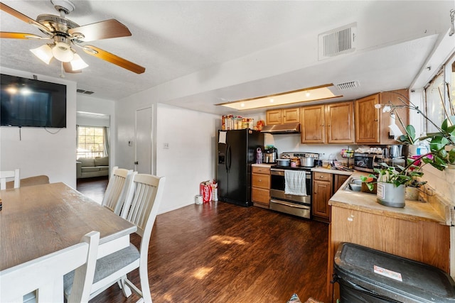 7322 Crownwest St Unit 7322, Houston, TX 77072 - kitchen featuring stainless steel appliances, under cabinet range hood, light countertops, dark wood-style flooring, and brown cabinets