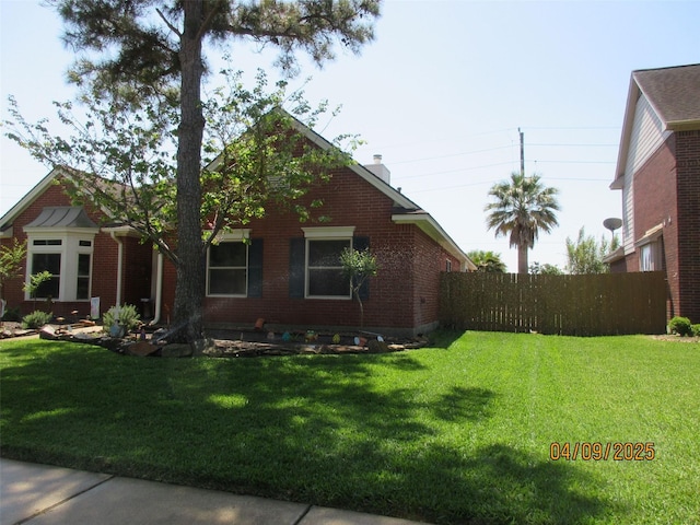 15014 Redbud Leaf Ln, Cypress, TX 77433 - view of home's exterior featuring brick siding and a chimney