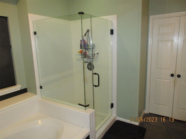15014 Redbud Leaf Ln, Cypress, TX 77433 - bathroom with a stall shower, a garden tub, tile patterned floors, and baseboards
