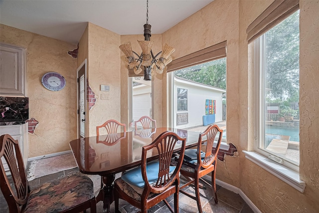 15014 Redbud Leaf Ln, Cypress, TX 77433 - dining space featuring a textured wall, healthy amount of natural light, and a chandelier