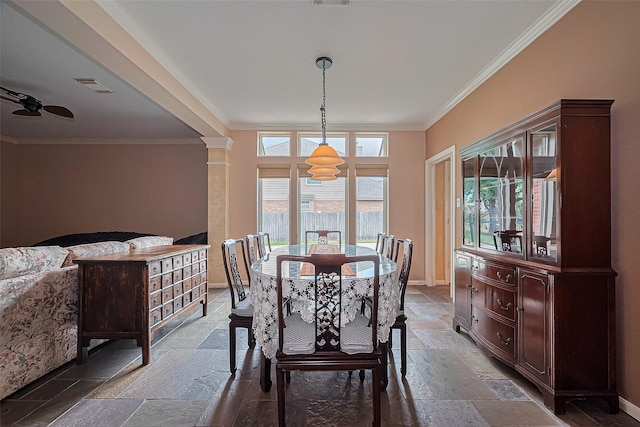 15014 Redbud Leaf Ln, Cypress, TX 77433 - dining space featuring stone tile floors, ornamental molding, and decorative columns