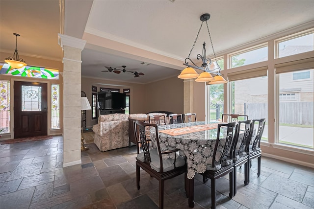 15014 Redbud Leaf Ln, Cypress, TX 77433 - dining space featuring stone tile flooring, crown molding, and decorative columns
