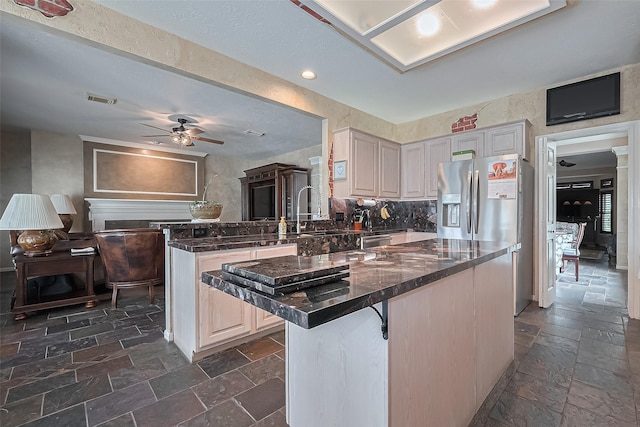 15014 Redbud Leaf Ln, Cypress, TX 77433 - kitchen featuring appliances with stainless steel finishes, stone tile floors, a ceiling fan, a breakfast bar area, and recessed lighting