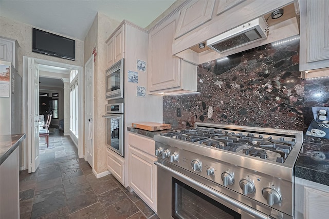 15014 Redbud Leaf Ln, Cypress, TX 77433 - kitchen with stainless steel appliances, stone tile floors, backsplash, and custom range hood