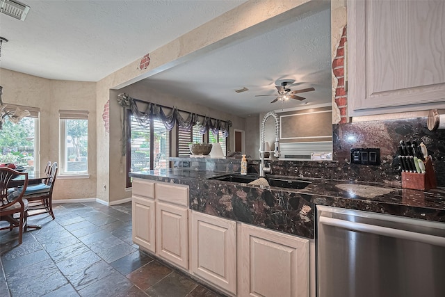 15014 Redbud Leaf Ln, Cypress, TX 77433 - kitchen featuring dishwasher, stone tile floors, a ceiling fan, a textured ceiling, and backsplash