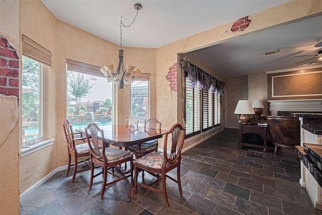 15014 Redbud Leaf Ln, Cypress, TX 77433 - dining area featuring stone tile floors, a chandelier, plenty of natural light, and ceiling fan