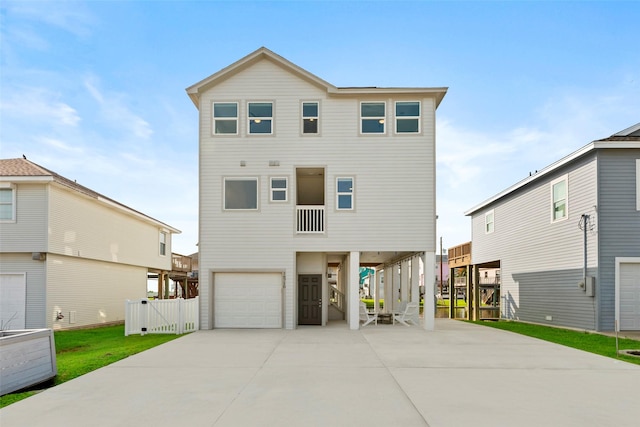 16710 Tahiti Way, Jamaica Beach, TX 77554 - rear view of house featuring an attached garage, a carport, driveway, and a gate